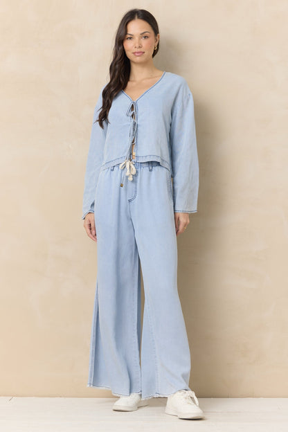 Light wash denim wide-leg pants with drawstring waist and side pockets