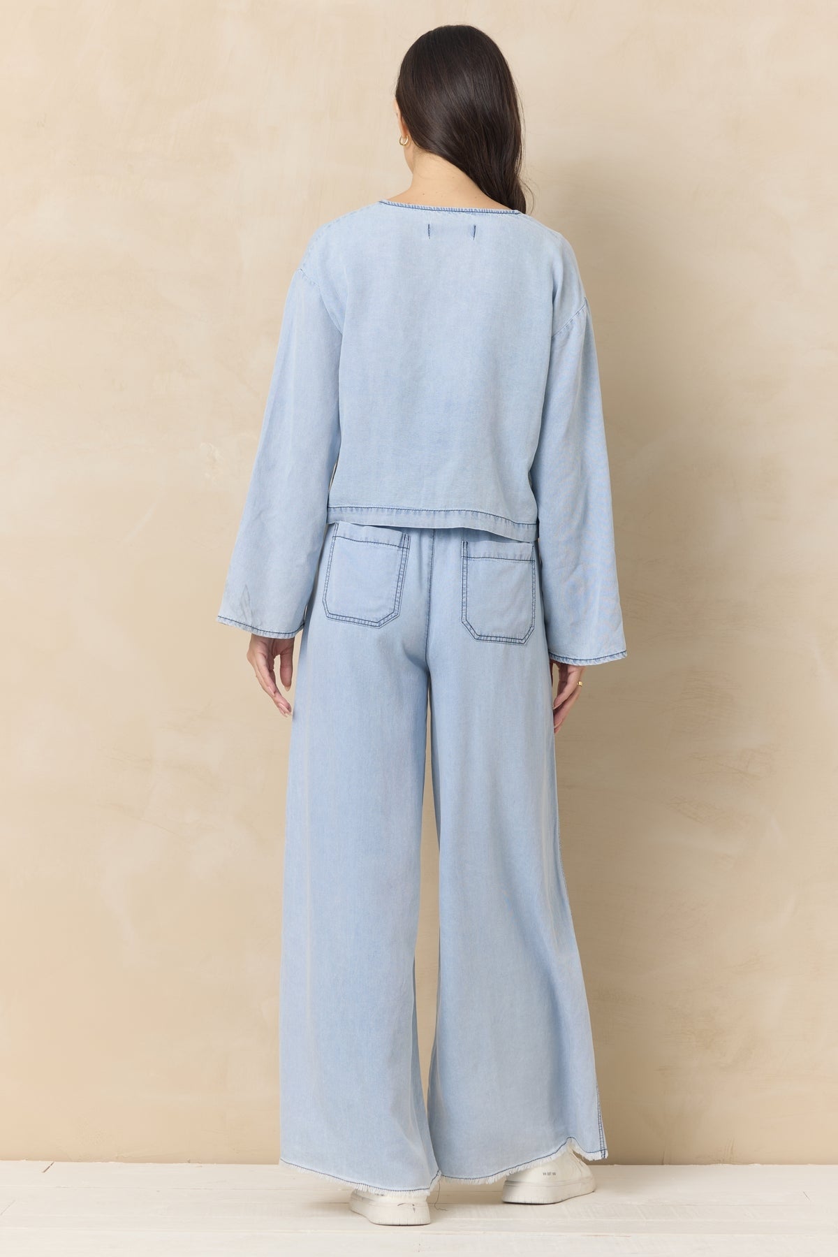Light wash denim wide-leg pants, back view, elastic drawstring waist