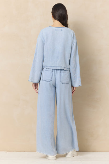 Light wash denim wide-leg pants, back view, elastic drawstring waist