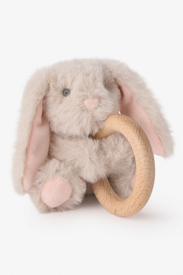 Plush bunny rattle toy with a wooden ring on a white background