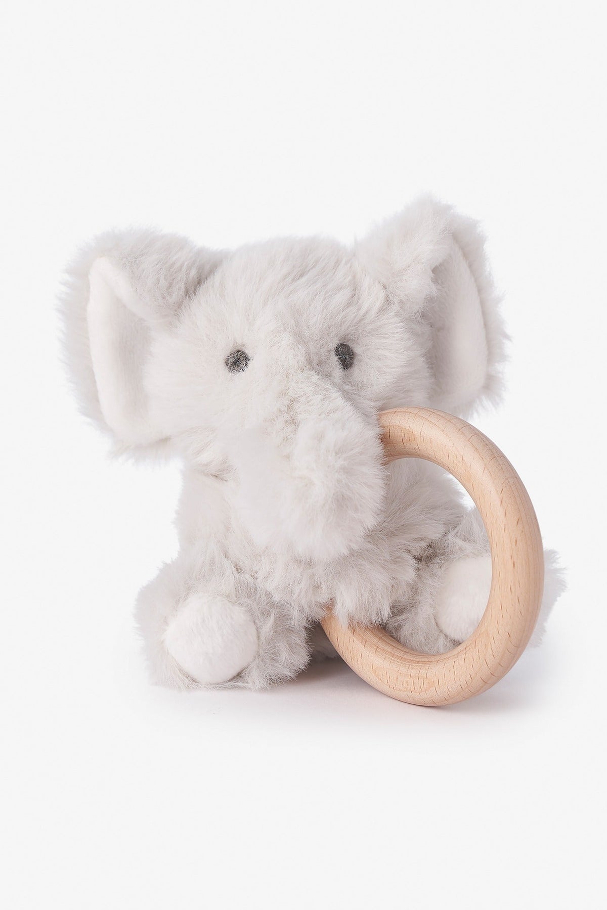 A plush elephant baby rattle toy in light gray faux fur, holding a natural light wood teething ring, set against a clean white background.