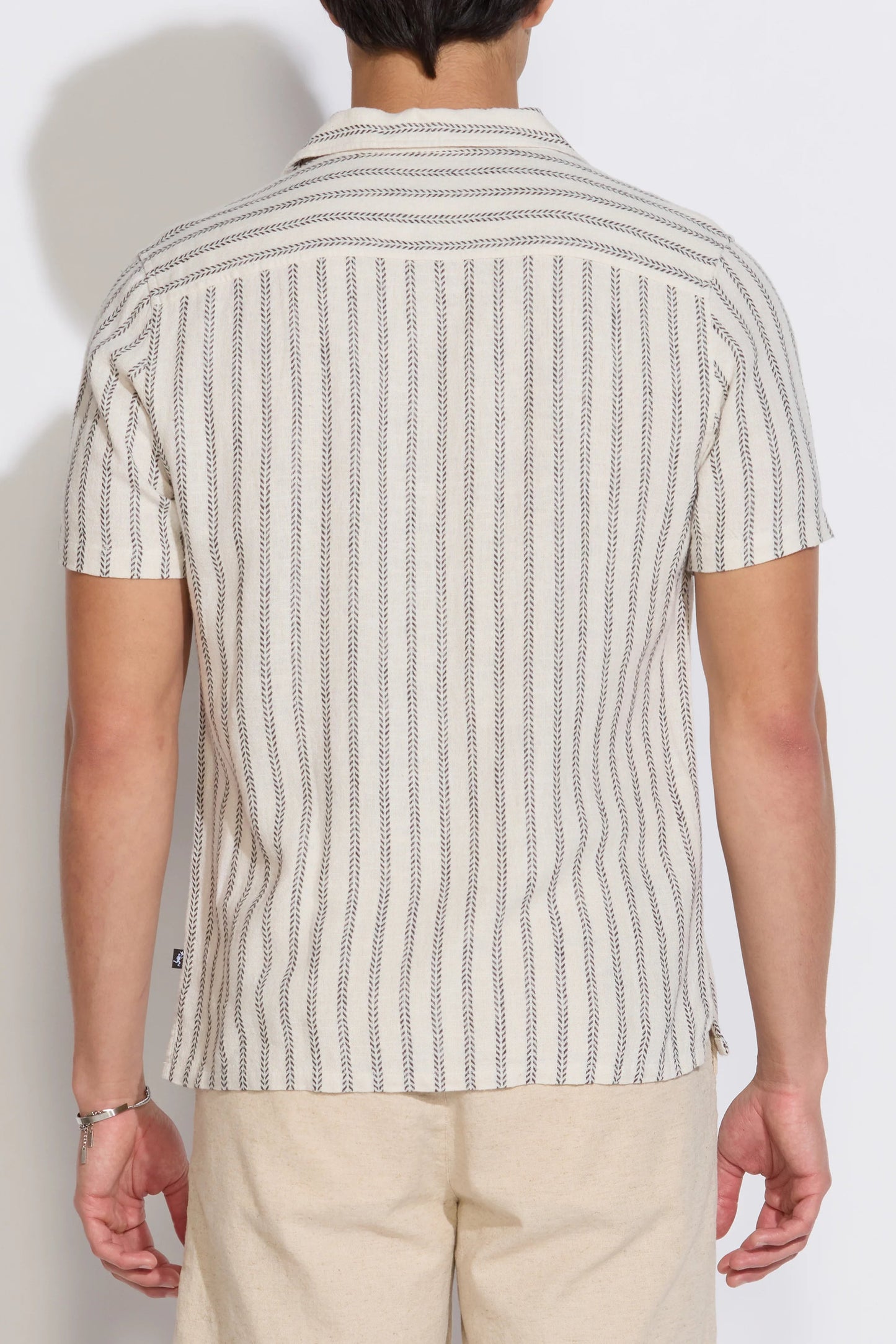 Back view of striped resort shirt with short sleeves and button placket