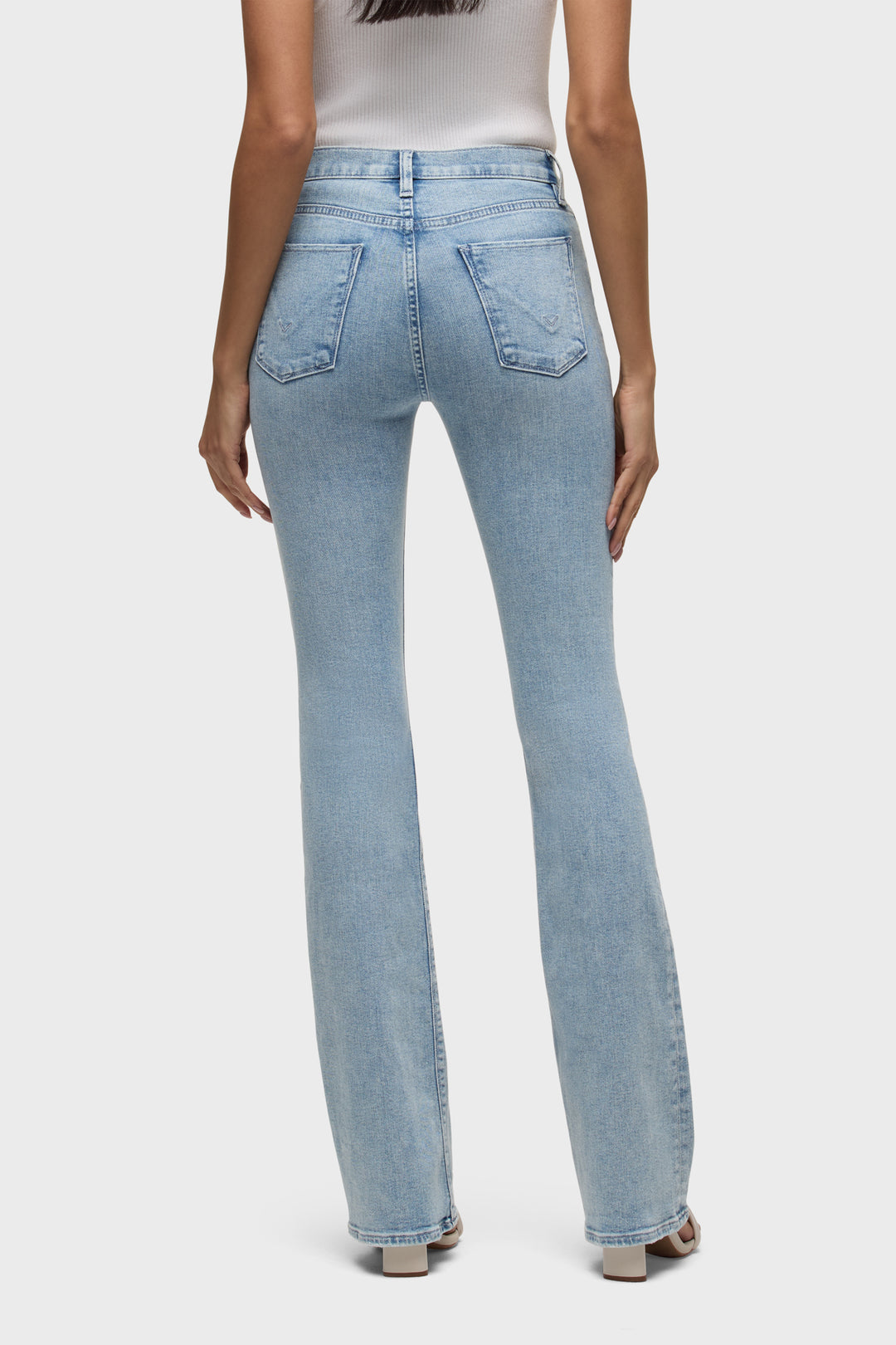 Back view: High-rise bootcut jeans, light blue wash, two back patch pockets