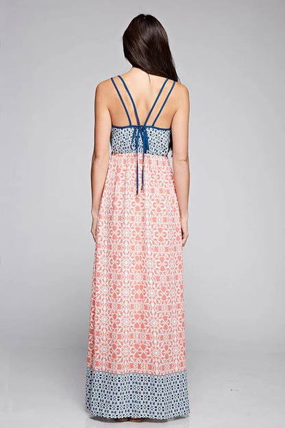Back view maxi dress with coral floral print, blue waistband trim, crossed spaghetti straps