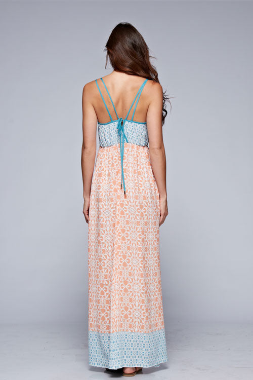 Back view of floral sleeveless maxi dress in coral and blue with crisscross straps