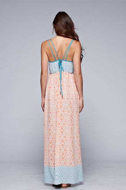 Back view of floral sleeveless maxi dress in coral and blue with crisscross straps