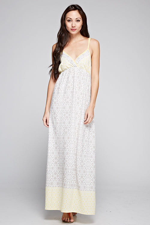 Floral sleeveless maxi dress in light gray with yellow border at the hem