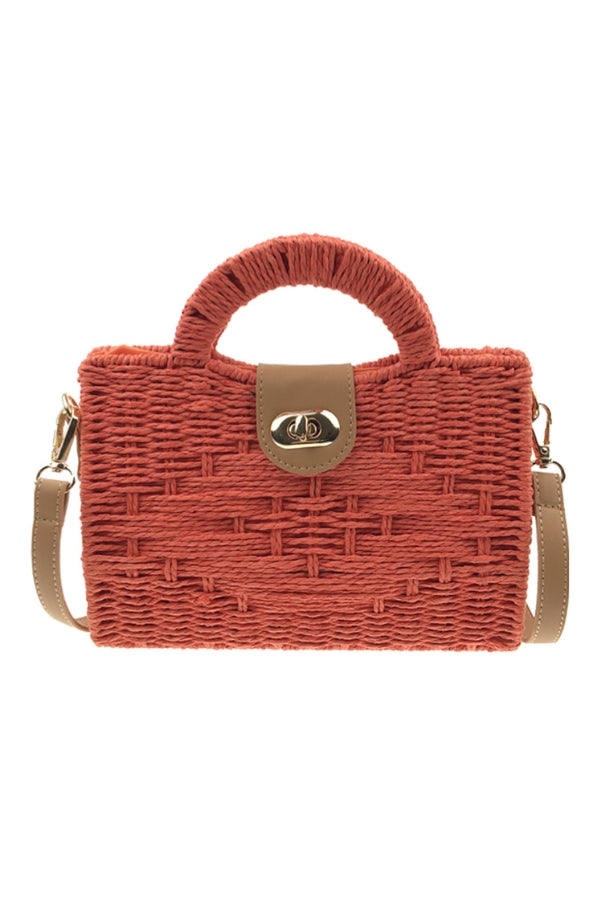 Rust woven straw tote bag with top handle, crossbody strap, and logo clasp