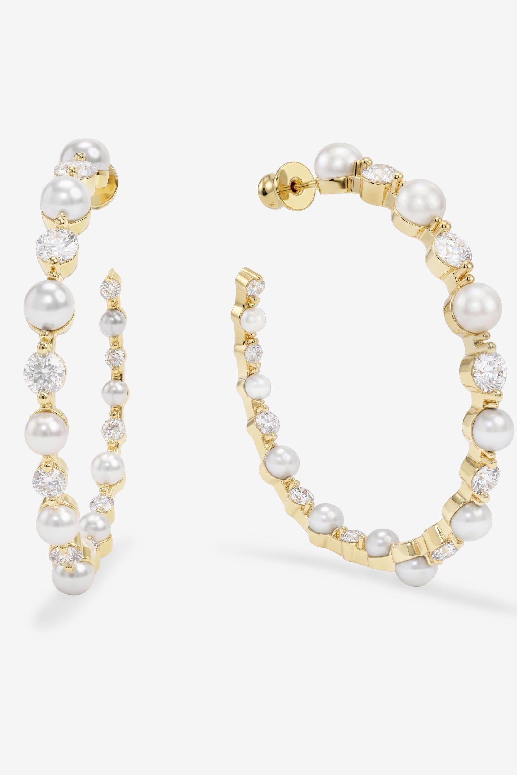 Gold hoop earrings with pearls on a white background