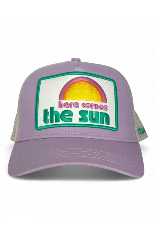 Lilac trucker cap with white mesh back and 'here comes the sun' front patch