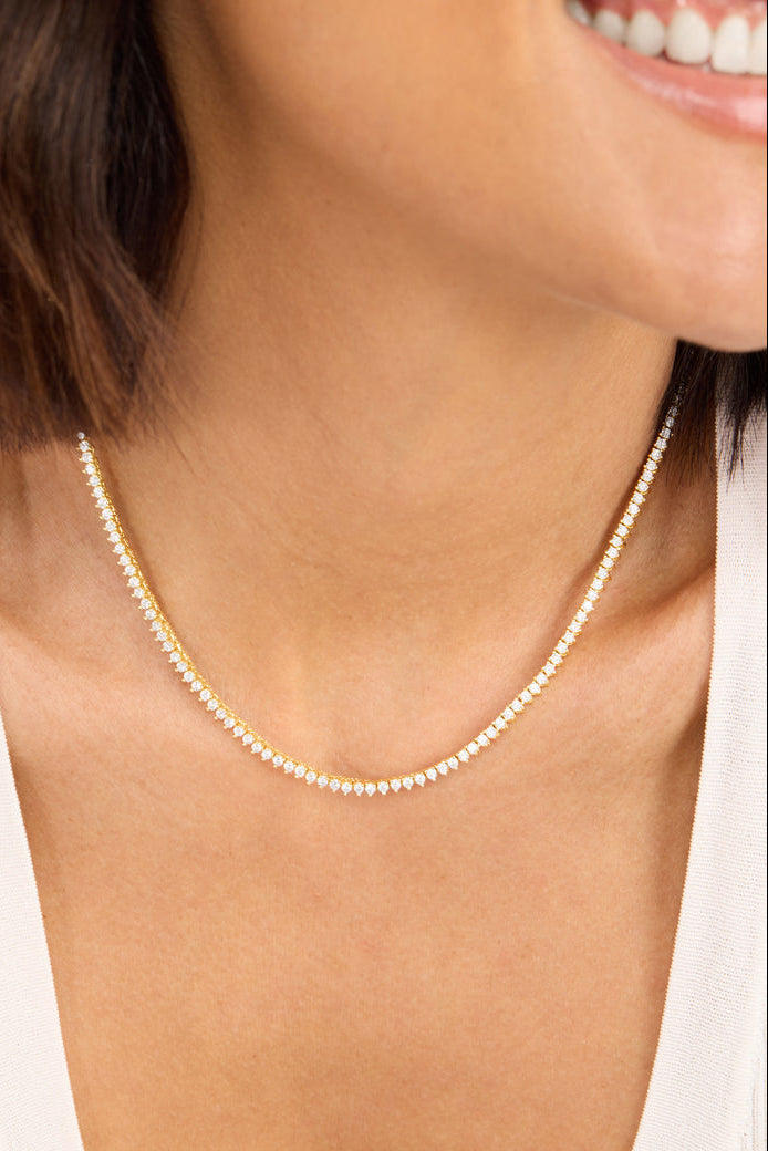 Tennis necklace with white stones on gold-tone chain, 16 in