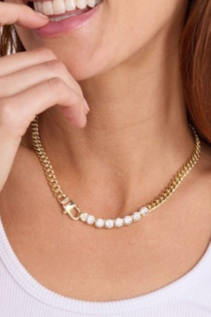 Gold necklace with pavé stones and rectangular charm links, worn at collarbone