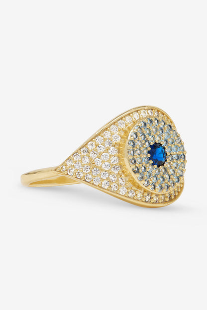 Gold evil eye ring with blue oval center and clear pavé stones