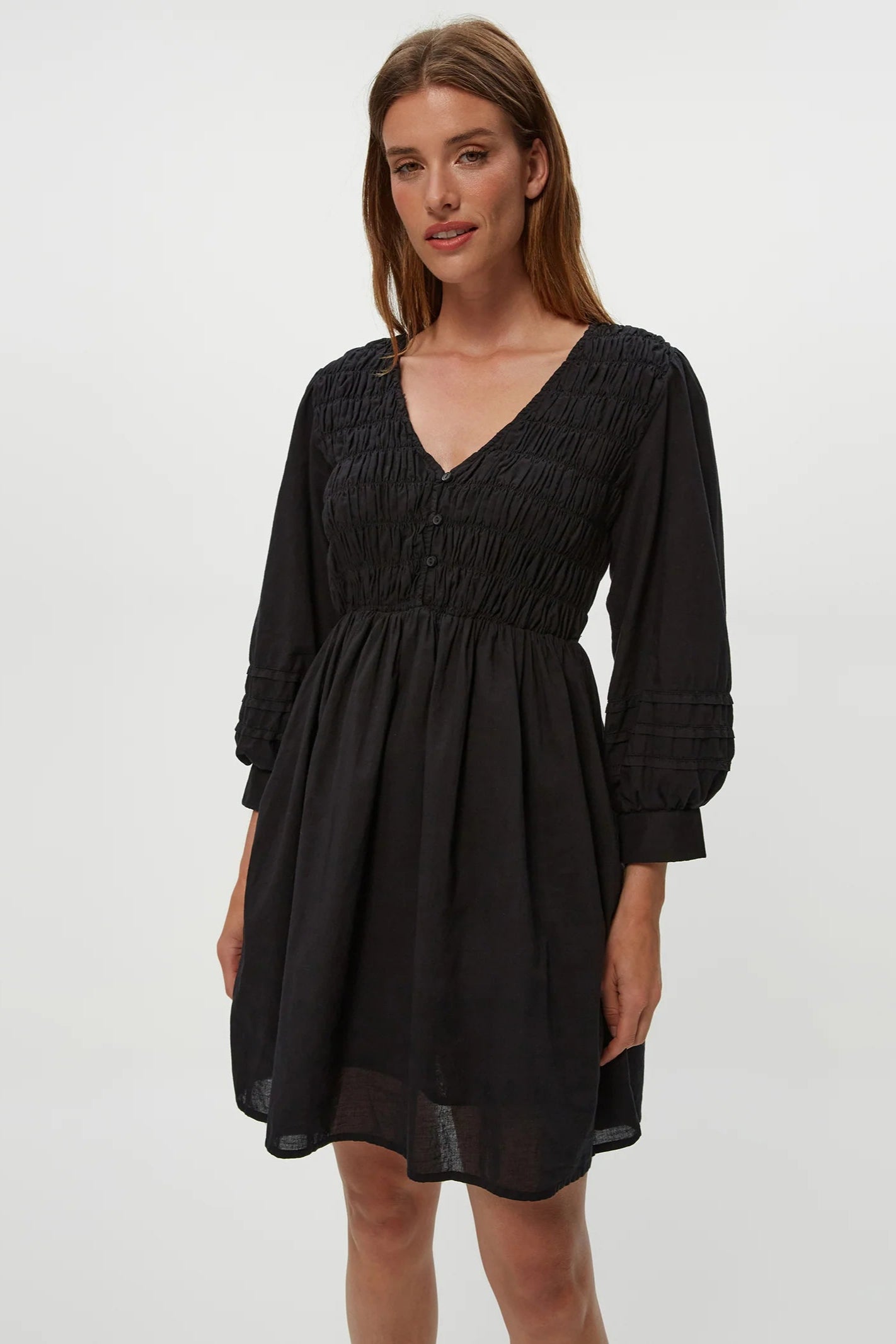 Zuri smocked mini dress in black front view