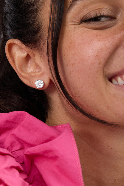 Silver-tone round stud earrings with clear cubic zirconia stone