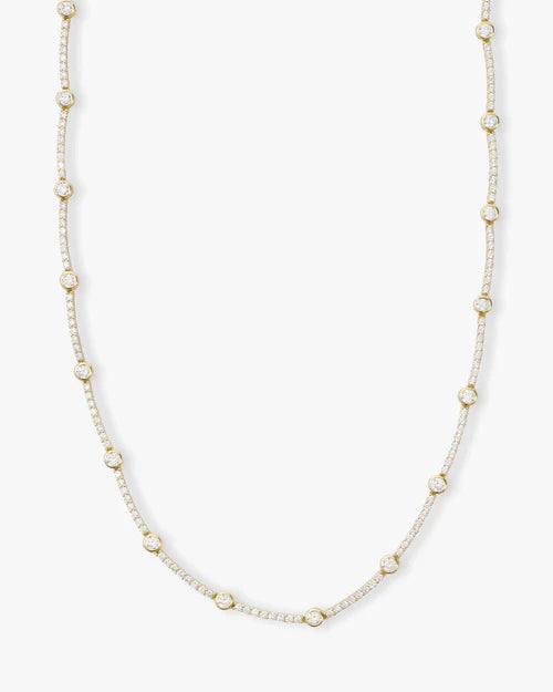 She's an icon station necklace 16" in gold with white diamonds