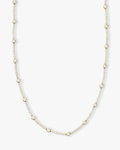 She's an icon station necklace 16" in gold with white diamonds