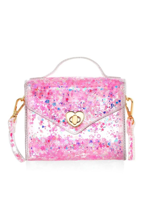 A pink glittery handbag with a clear vinyl body, gold-tone hardware, a top handle, and a detachable shoulder strap, shown on a plain white background.