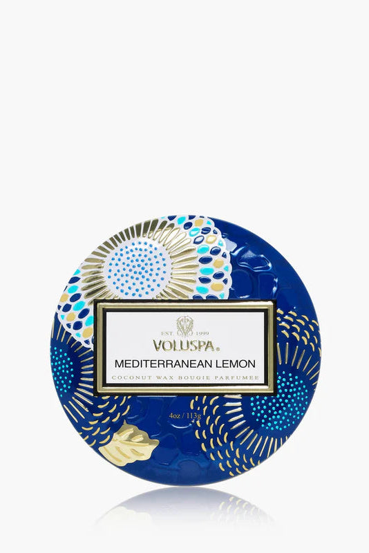 Mini tin candle in blue patterned tin with Mediterranean Lemon label and lit wick