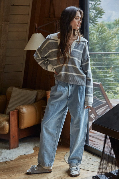 Striped pullover sweater in slate blue with off-white V-neck and ribbed cuffs, long sleeves