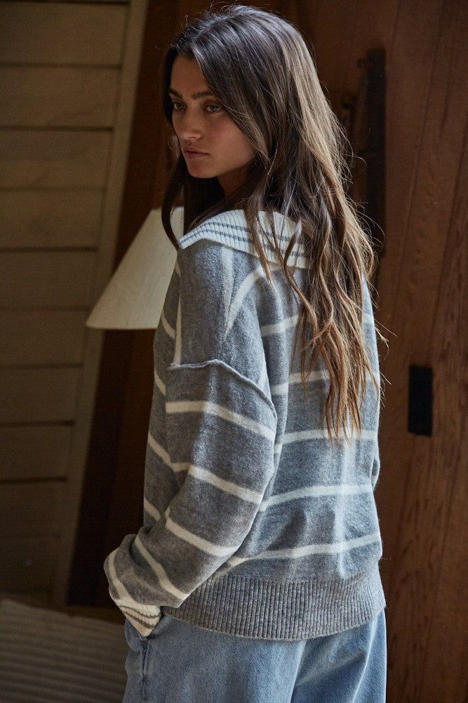 Striped pullover sweater in slate blue with off-white V-neck, long sleeves, ribbed hem