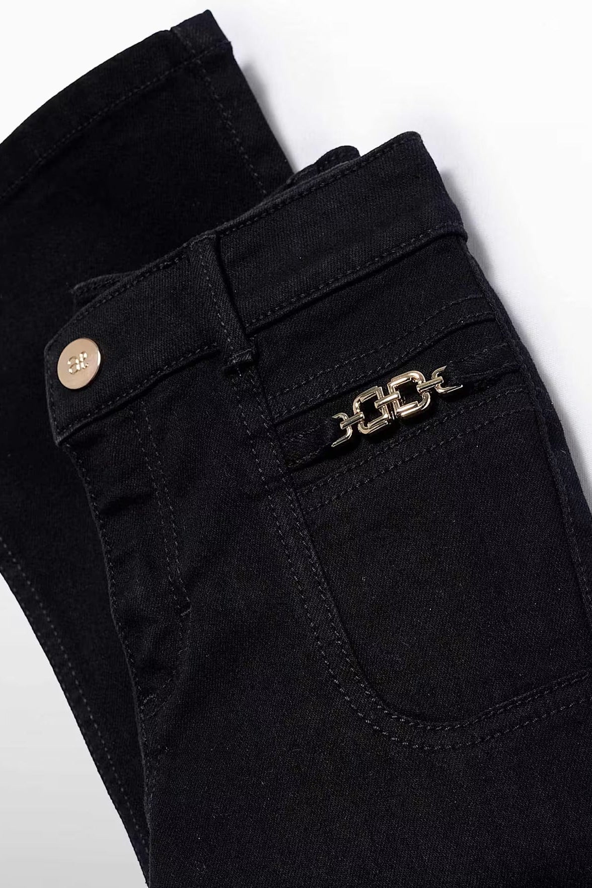 FLARED DENIM PANTS IN BLACK POCKET DETAIL VIEW