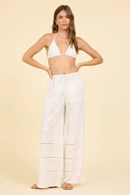 White wide-leg eyelet pants with elastic waistband and tiered stitch seams