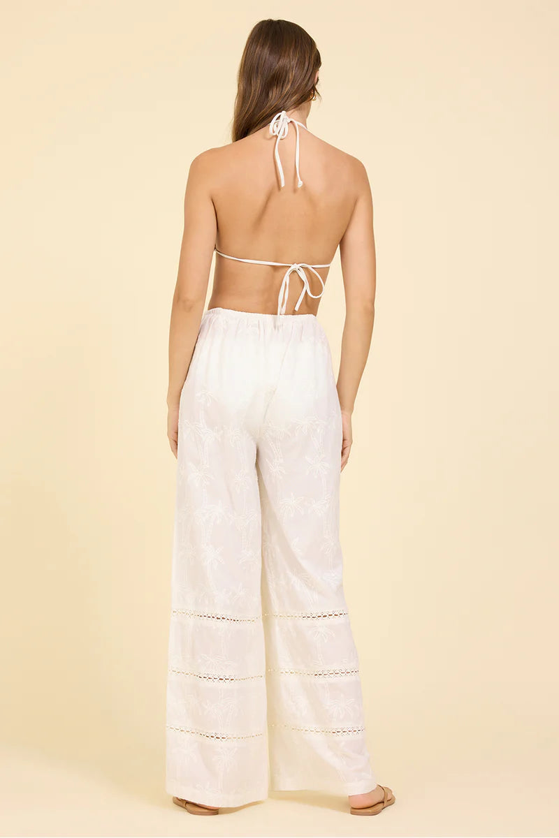 White wide-leg eyelet pants, back view, elastic waist and long straight legs