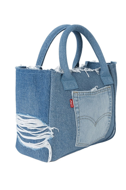 Denim tote bag with distressed details on a white background