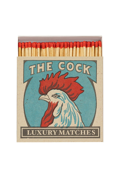 The Cock luxury matchbox with rooster graphic, red match heads and wood sticks
