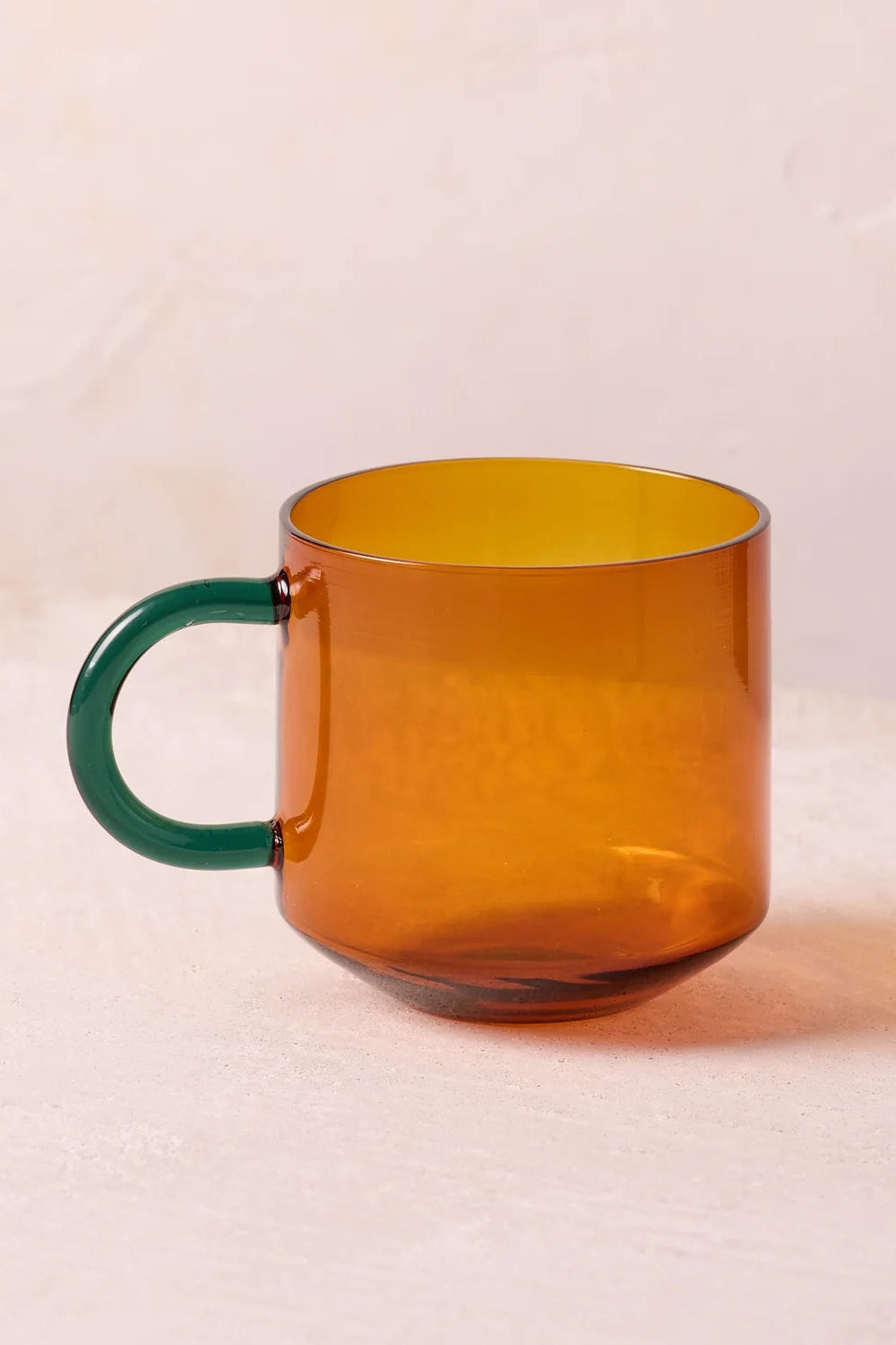 NIKO glass mug with amber body and green handle