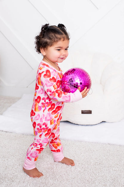 Infant convertible coverall with heart print and front zipper, pink cuffs