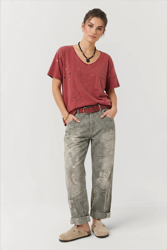 Light gray straight jeans with distressed patches and cuffed hems, mid-rise.