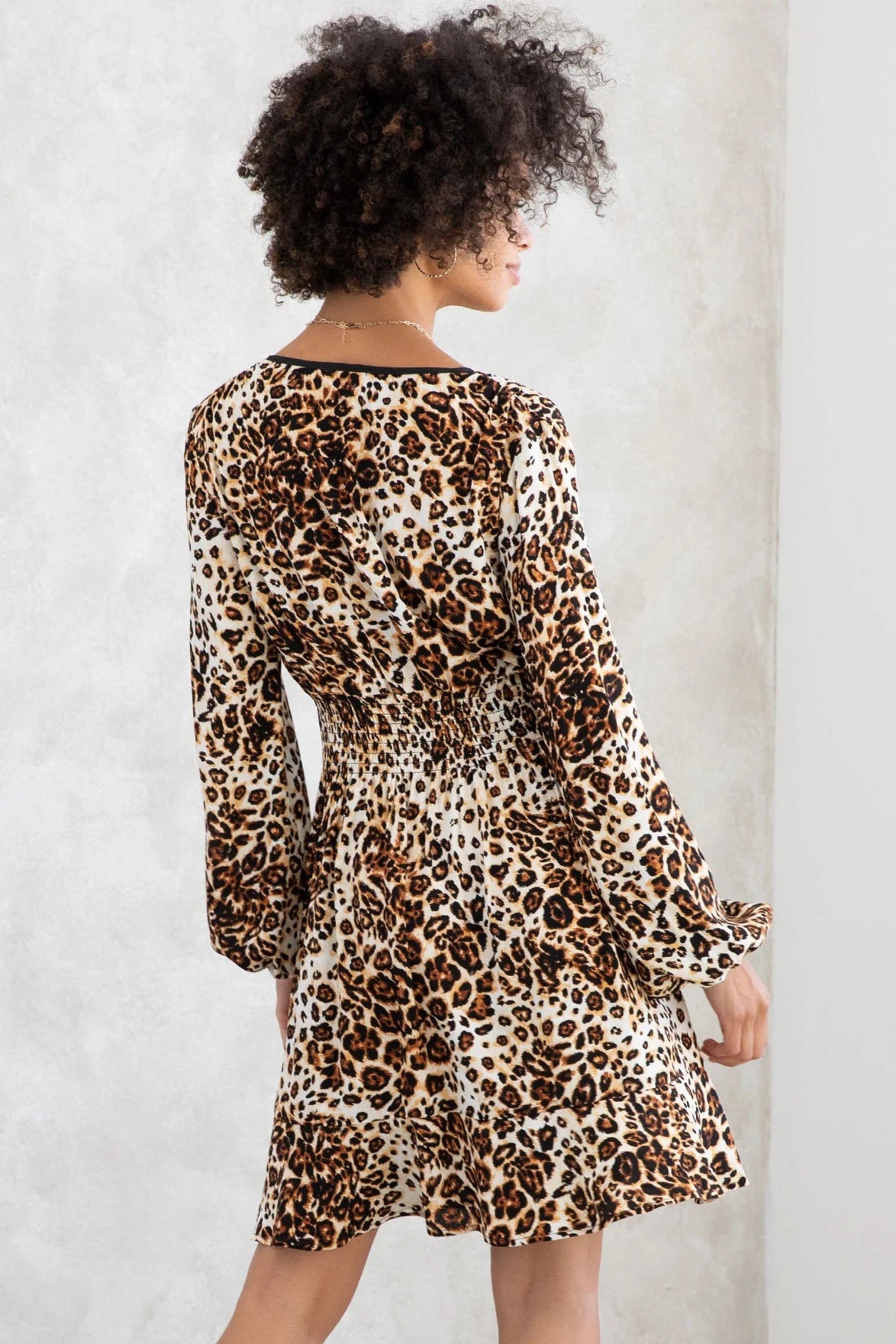 Leopard print long sleeve peasant mini dress in camel brown back view