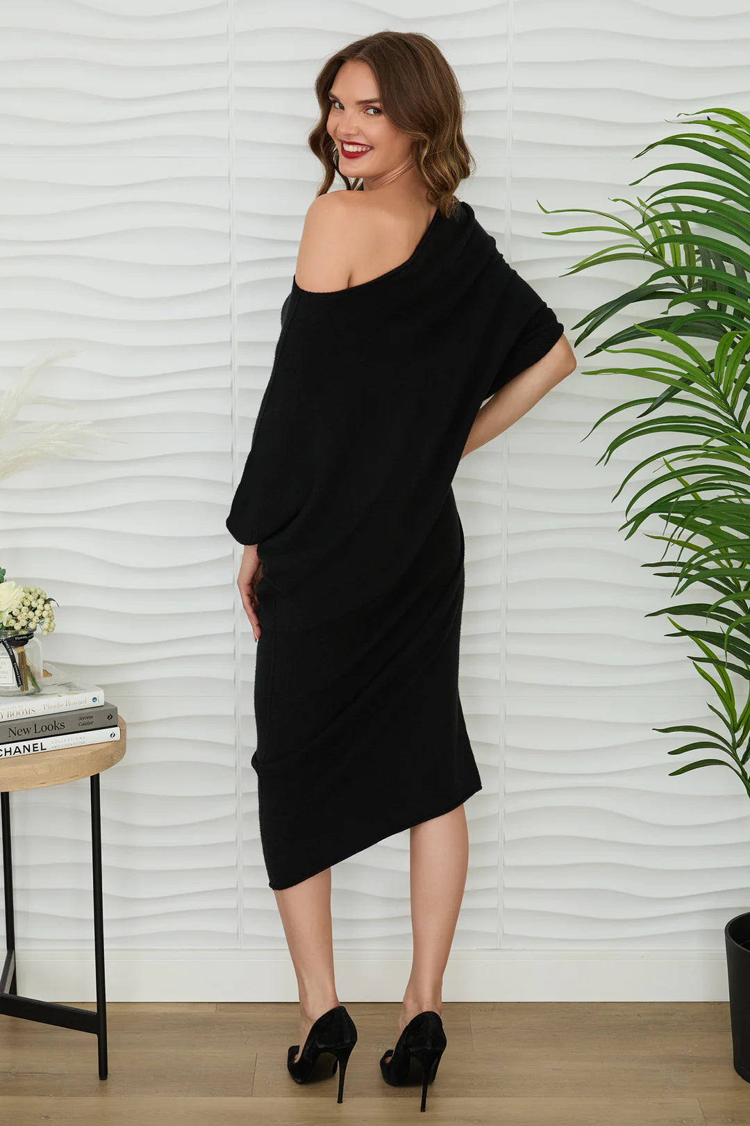ASYMMETRICAL SWEATER DRESS IN BLACK BACK VIEW