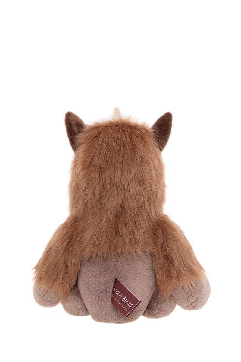 Back view of a quarry plush toy with a visible brand label on a white background