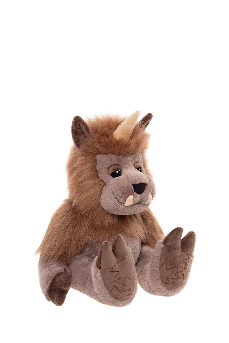 Side view of plush toy resembling a quarry creature with brown fur and horns on a white background