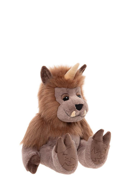 Side view of plush toy resembling a quarry creature with brown fur and horns on a white background