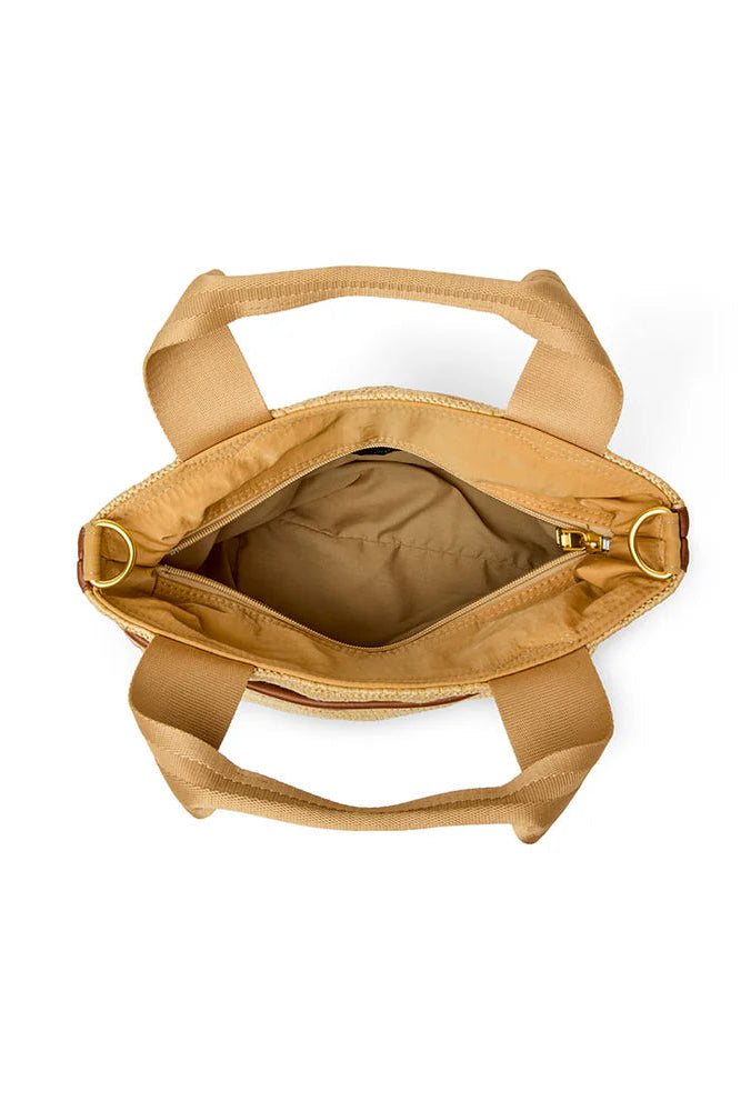 Tan raffia tote open interior showing lined main compartment and top zip closure
