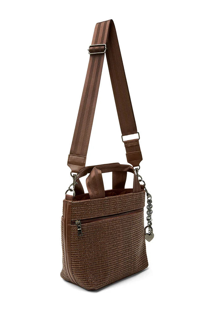 Brown raffia crossbody tote with long strap, chain detail, and front zip pocket