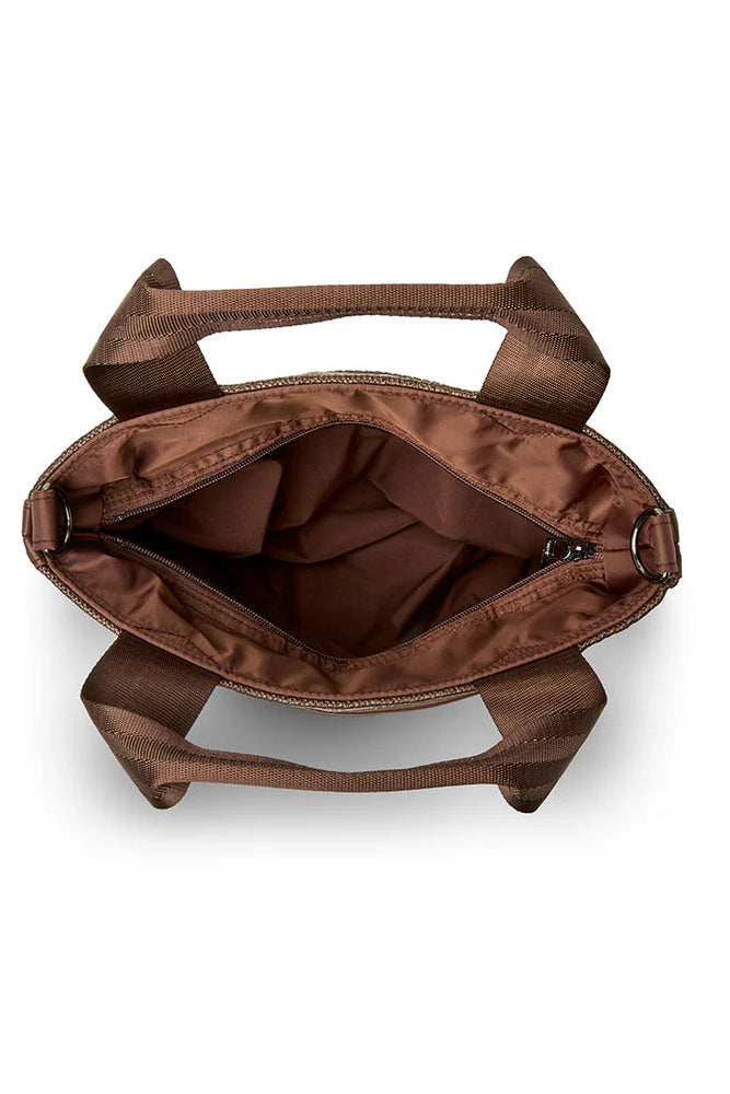 Brown raffia tote open interior view with wide top handles and inner lining