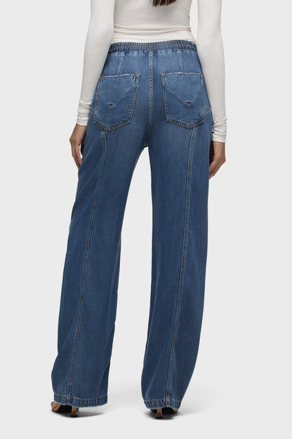 Blue denim drawstring pants, back view with flap pockets and elastic waist