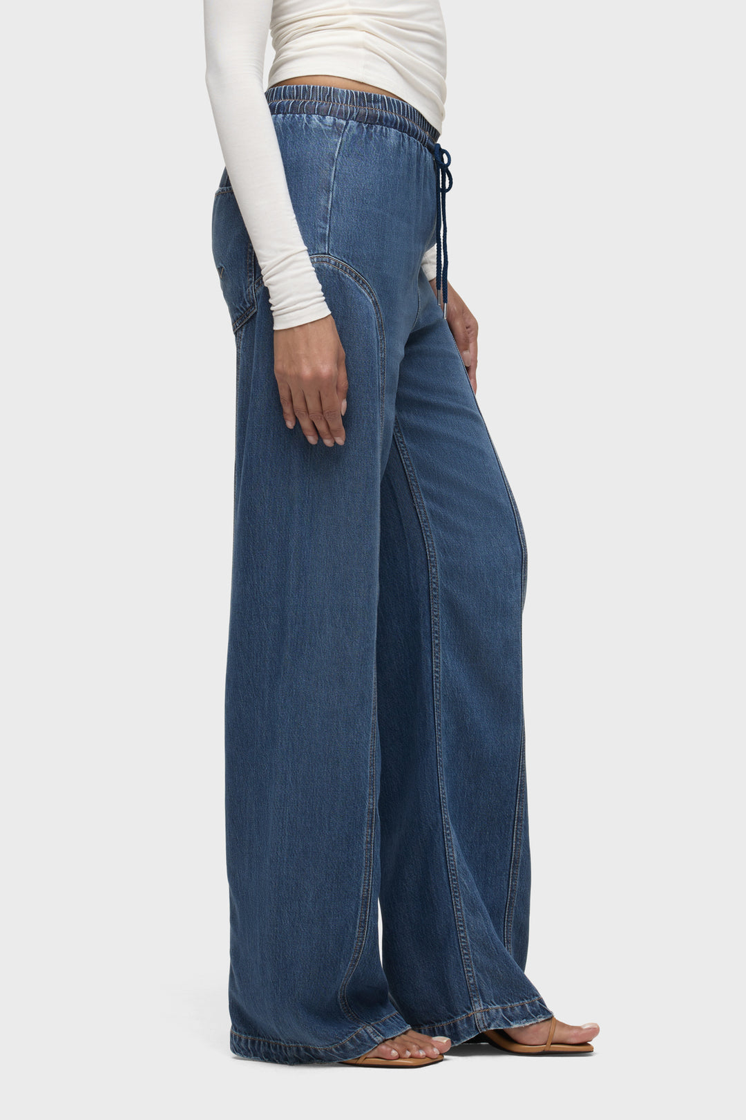 Blue denim drawstring pants with side drawstring and relaxed wide legs