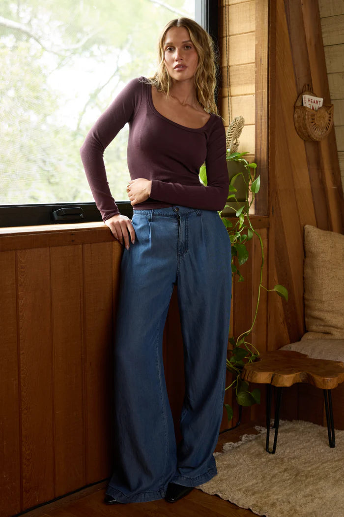 Dark blue wide-leg denim trousers with high rise elastic waistband and side pockets