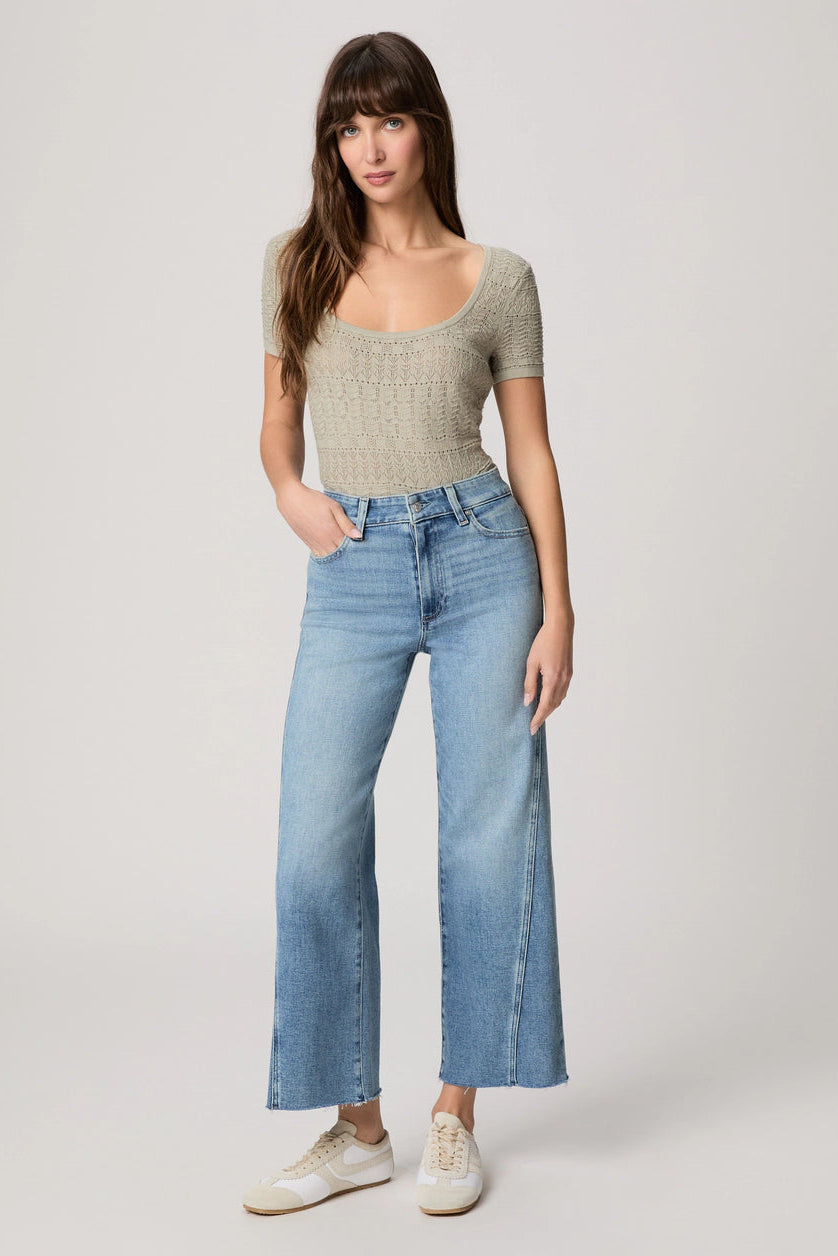 Light blue wide-leg jeans with raw hem, front pockets, and belt loops