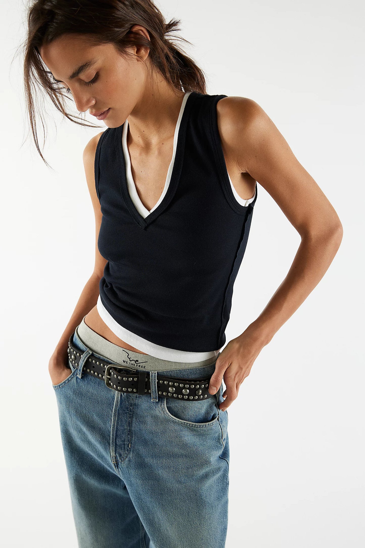 Black V-neck sleeveless tank top with white trim at neckline and hem