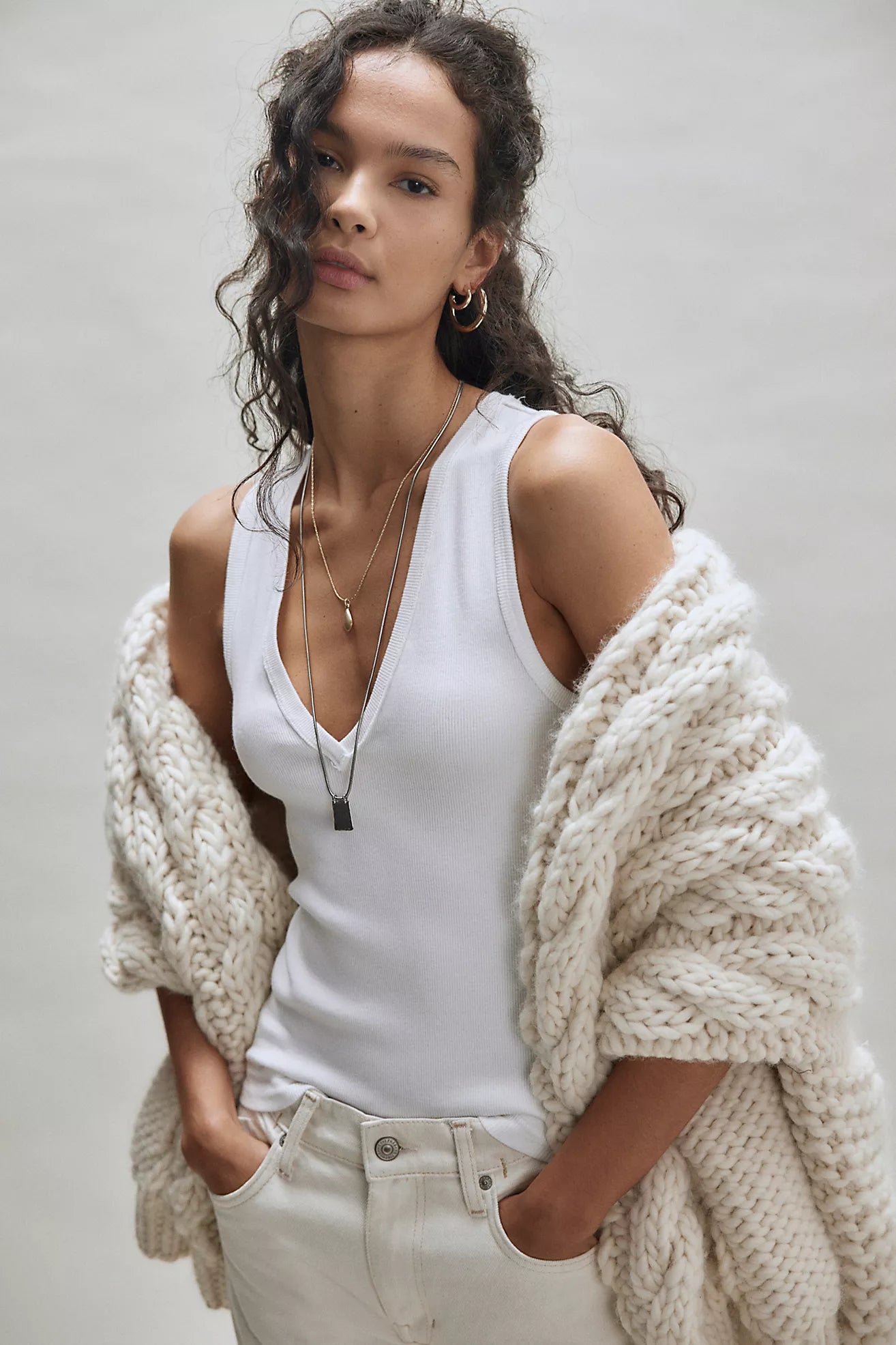 Ivory V-neck sleeveless tank top with narrow white contrast trim