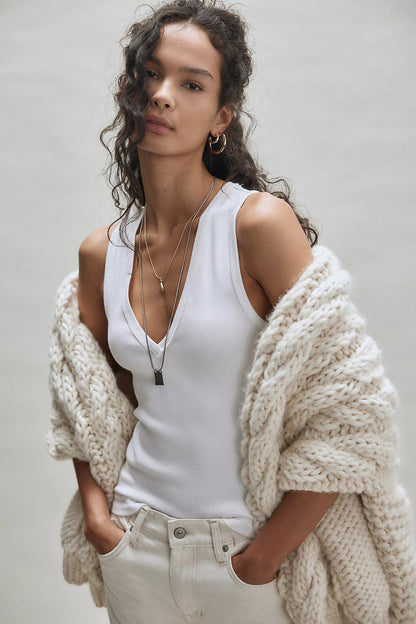 Ivory V-neck sleeveless tank top with narrow white contrast trim