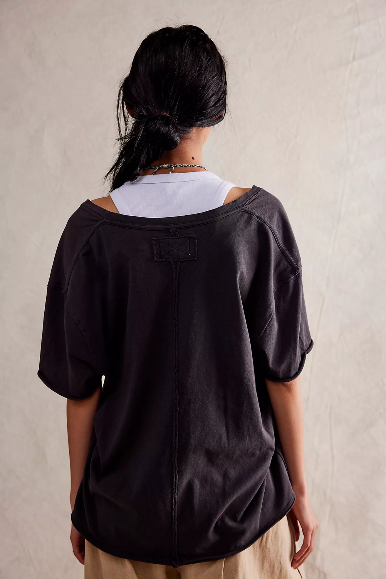 Black short-sleeve T-shirt, back view with V-shaped yoke and central seam