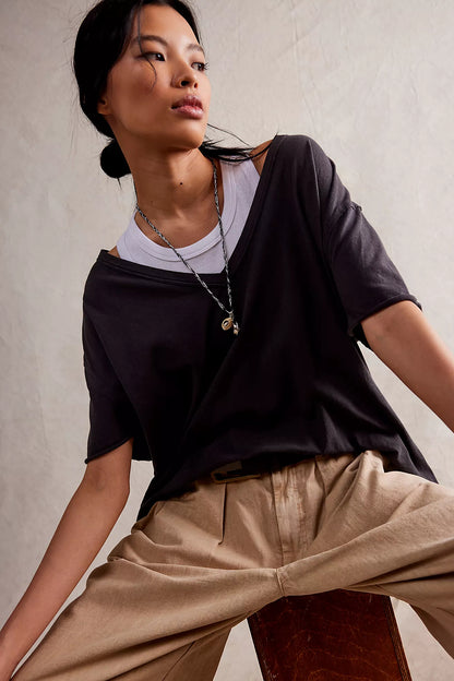 Black short-sleeve V-neck T-shirt with relaxed fit and draped front